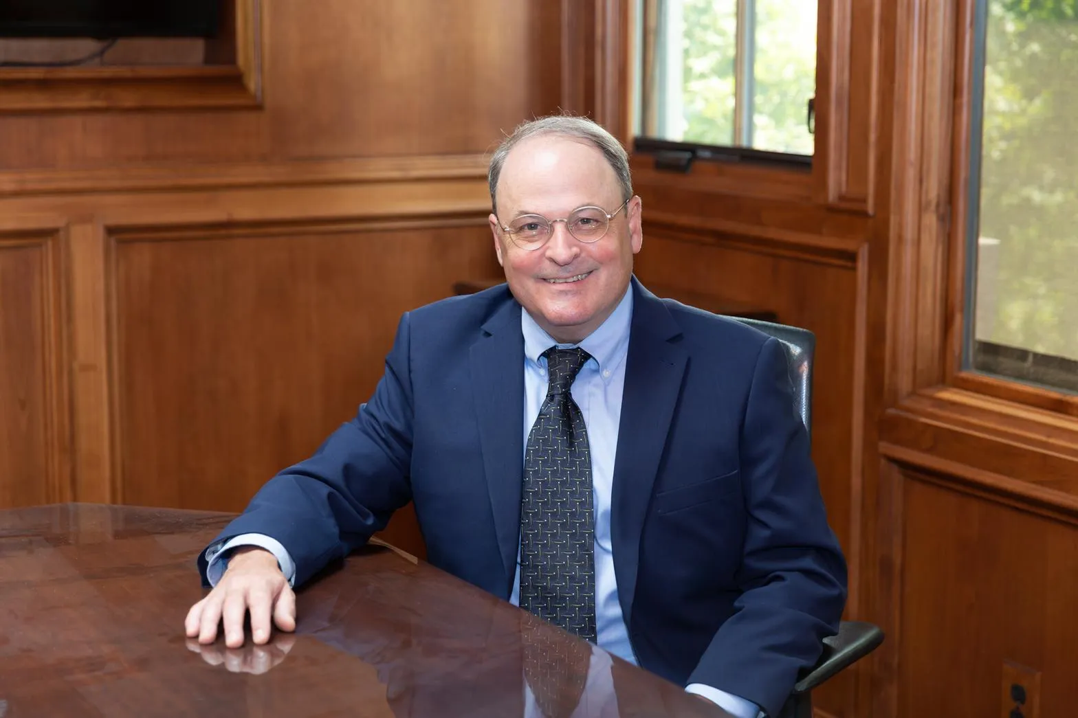 Attorney Tony Bayard de Volo seated at the conference table in his wood-paneled San Jose office